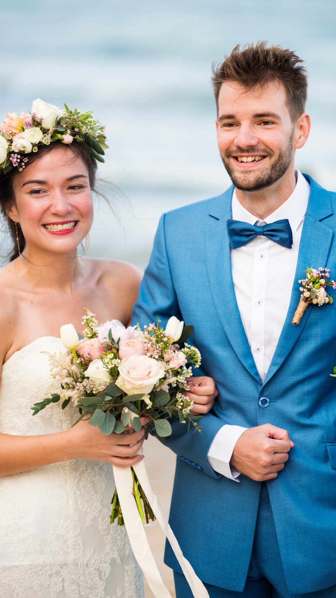 young-couple-in-a-wedding-ceremony-at-the-beach-AB4FXRM-scaled.jpg